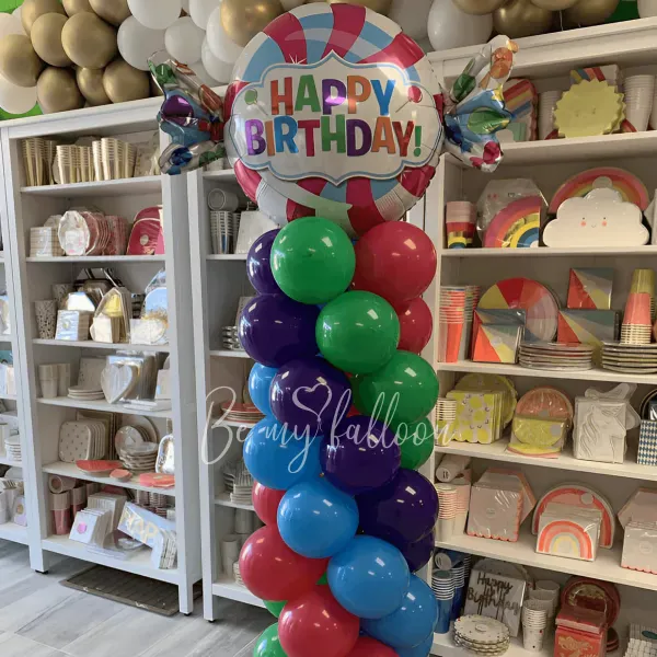 Multicolour pillar with a Candy Happy Birthday balloon composition